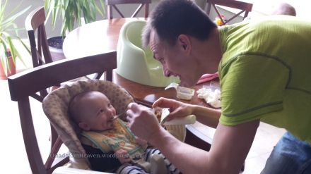Daddy feeding Isaac